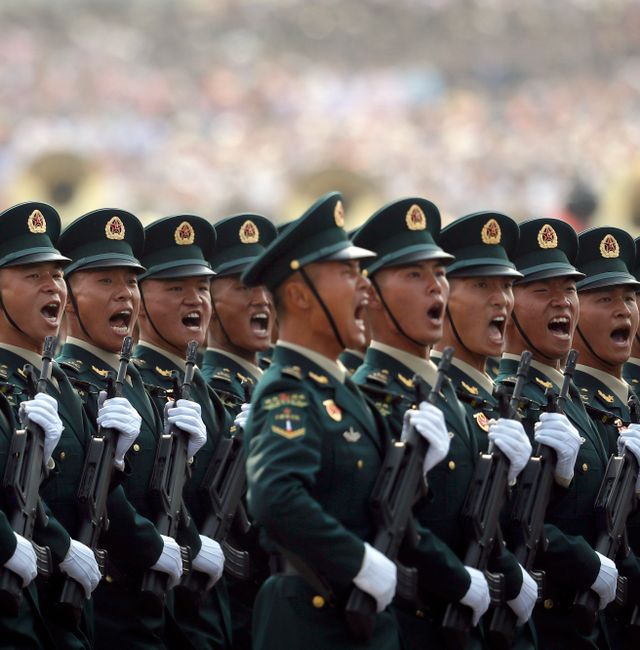 Members of China's People's Liberation Army (PLA) Rocket Force let out a yell as they march in formation during a parade to commemorate the 70th anniversary of the founding of Communist China in Beijing, Tuesday, Oct. 1, 2019. Mark Schiefelbein / AP