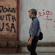 En man i Teheran framför USA-kritiska budskap.