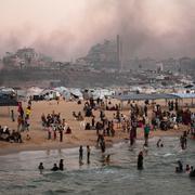 Palestinier vid strandpromenaden intill ett tältläger i Gaza Citys hamn den 13 juni.