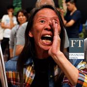 A woman reacts during the counting of the votes of the Hong Kong council elections, in a polling station in Hong Kong, China November 25, 2019.