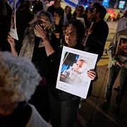 Activists hold photos of children killed across Israel, the Palestinian territories, Iran and Lebanon during a silent vigil calling for an end to the war in Tel Aviv, Israel, Saturday, April 4, 2026. (AP Photo/Maya Levin)  XOB127