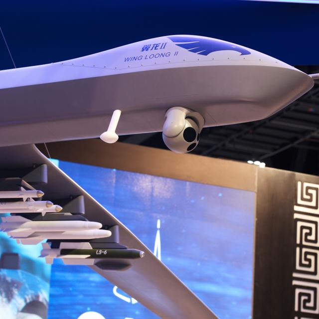 FILE - In this Sunday, Feb. 25, 2018, file photo, a model of the Wing Loong II weaponized drone hangs above the stand for the China National Aero-Technology Import & Export Corp. at a military drone conference in Abu Dhabi, United Arab Emirates. Jon Gambrell / AP