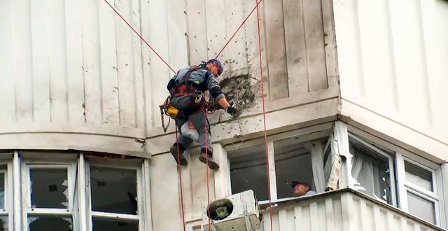 Utredare inspekterar skada på byggnad i Moskva. AP