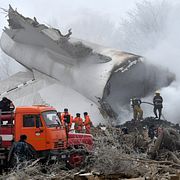 Brandmän jobbar vid flykplansvraket efter kraschen i Kirgizistan.
