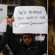 Två män från Syrien håller upp skyltar med texten ”Vi är emot sexism” och ”Vi respekterar tyska värderingar” vid en demonstration utanför centralstationen i Köln förra veckan.