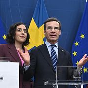 Statsminister Ulf Kristersson (M), flankerad av energi- och näringsminister Ebba Busch (KD) och utbildnings- och integrationsminister Simona Mohamsson (L). I bakgrunden skymtar SD:s Jimmie Åkesson.