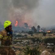 A firefighter works as forest fire is burning near Latrun, Israel, Wednesday, April 30, 2025. (AP Photo/Ohad Zwigenberg)  ASC124