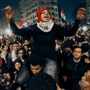 An Egyptian woman celebrates with other people after President Hosni Mubarak resigned and handed power to the military at Tahrir square, in Cairo, Egypt, Friday, Feb. 11, 2011.