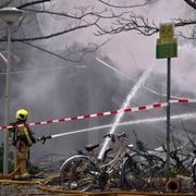 A firefighter works at the sight of an explosion at an apartment block in The Hague, Saturday, Dec. 7, 2024. (AP Photo/Phil Nijhuis)  lbl112