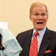 Senatorn Bill Nelson håller upp en av de fallerande korckkuddarna.