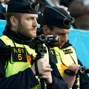 Poliser filmar supportrar som tänder bengaler/arkivbild, inför fotbollsallsvenskan mellan Hammarby och Djurgården.