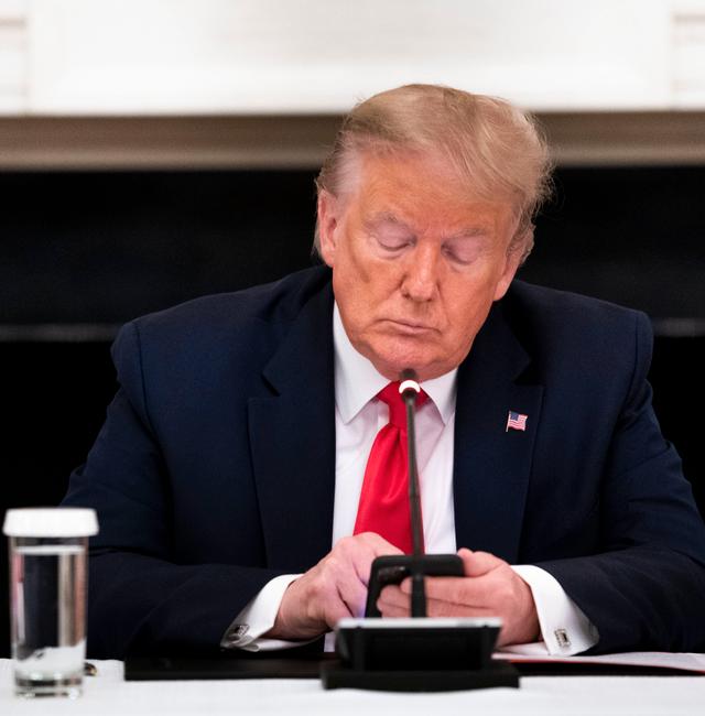 FILE -- President Donald Trump types on his phone during a roundtable with governors at the White House in Washington on June 18, 2020. Trump, who was famously averse to leaving records of his communications and had long avoided text and emails, has begun texting in 2023, associates say. DOUG MILLS / NYT