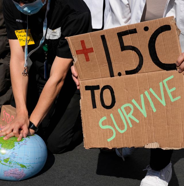 Demonstrators pretend to resuscitate the Earth while advocating for the 1.5 degree warming goal to survive at the COP27 U.N. Climate Summit, Nov. 16, 2022, in Sharm el-Sheikh, Egypt.  Peter Dejong / AP