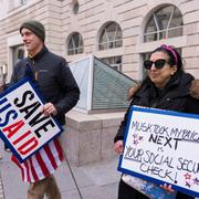 Demonstranter protesterar mot USAID-nedskärningen.