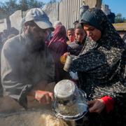 Palestinier får livsmedel vid ett matutdelningscenter i Deir al-Balah, centrala Gazaremsan. 