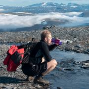 En fjällvandrare dricker vatten.