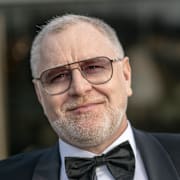 Dermot Clemenger gömmer sig utomlands efter att han misstänkts för sexköp.