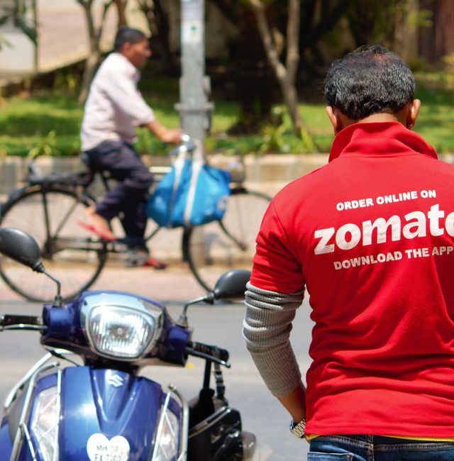Mumbai/India - April 6, 2019 : Delivery Boy of Zomato, one of the leading online food delivery startup in the food-tech space, waiting to pick up order in Hiranandani, Powai. Shutterstock