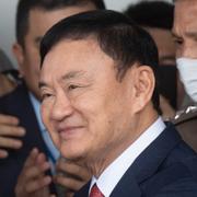 Thailands förra premiärminister Thaksin Shinawatra möts av supportrar på Don Muang flygplatsen i Bangkok, Thailand. 