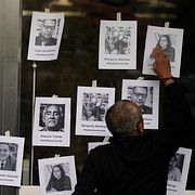 En man sätter upp fotografier av dödade journalister under en demonstration utanför riksåklagarens kontor i Mexico City 2022. Året blev det dödligaste någonsin för journalister i landet. 