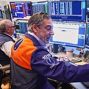 Trader John Romolo, right, works on the floor of the New York Stock Exchange, Wednesday, April 22, 2026. (AP Photo/Richard Drew)  NYRD307