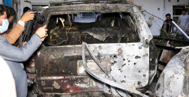 Afghanska journalister fotografer bilen efter USA:s drönarattack. Khwaja Tawfiq Sediqi / TT NYHETSBYRÅN