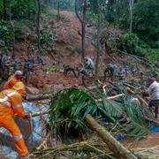 Räddningsarbetare letar efter överlevande i Koottickal i Kerala.
