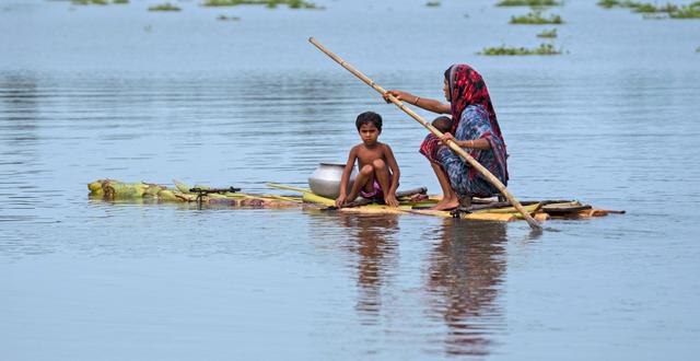 Kvinna och pojke i nordöstra Indien under sommarens översvämningar i regionen. Anupam Nath / AP