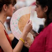 Demonstrators use fans to help with the high temperature during a protest against the housing crisis affecting Portugal, in Lisbon, Saturday, June 28, 2025. (AP Photo/Armando Franca)  XAF108