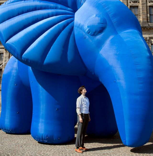 Marlene Engelhorn at a Millionaires for Humanity event in Amsterdam in late August, where activists were calling for wealth to be taxed. The inflatable next to her is meant to represent “the elephant in the room” of tax justice. Credit...  MASHID MOHADJERIN / NYT