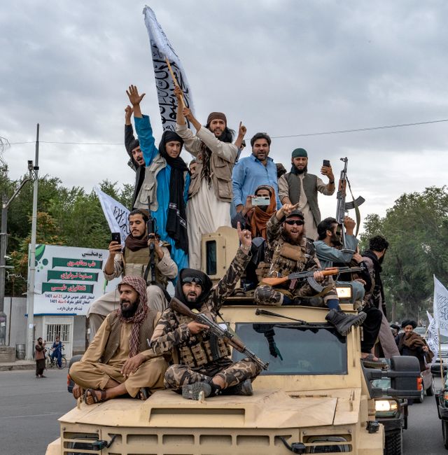 Taliban fighters celebrate one year since they seized the Afghan capital, Kabul, in front of the U.S. Embassy in Kabul, Afghanistan, Monday, Aug. 15, 2022. Ebrahim Noroozi / AP