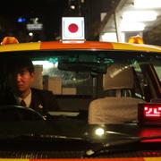 Japansk taxi. Arkivbild. 