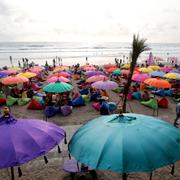 People spend their time at Kuta beach on the popular tourist island of Bali, Indonesia on Jan. 20, 2023.