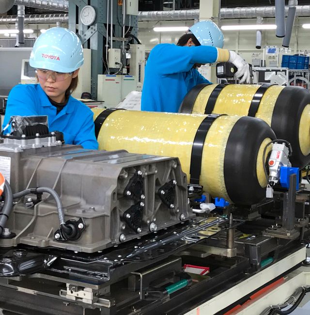 Oct. 30, 2017, photo, workers of Toyota Motor Corp. set hydrogen-stored tanks, in yellow, to be placed into a Mirai fuel cell vehicle at the automaker's Motomachi plant, in Toyota, western Japan. Yuri Kageyama / TT NYHETSBYRÅN