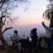 People gather atop Mount Qassioun, overlooking to the city and was opened to the public after the fall of the Assad regime in Damascus, Syria, Thursday, Jan. 2, 2025. 