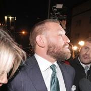 McGregor lämnar rättegången tillsammans med sin partner på fredagen.