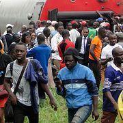 Människor hjälper varandra ta sig ut ur det urspårade tåget i Eseka, Kamerun.