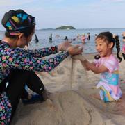 En flicka och hennes mamma leker på stranden i Wonsan-Kalma, den 2 juli.