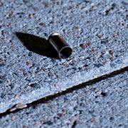 En tomhylsa innanför avspärrningarna efter att en man i 50-årsåldern har skjutits i benet av polis vid polishuset i Helsingborg. 
