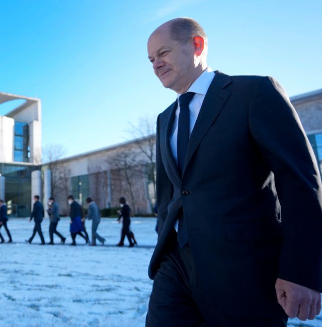German Chancellor Olaf Scholz, front, and the members of the government, rear, leave after a family photo as part of a one-day closed meeting of the German government at the Chancellery in Berlin, Germany, Friday, Jan. 21, 2022.  Michael Sohn / AP