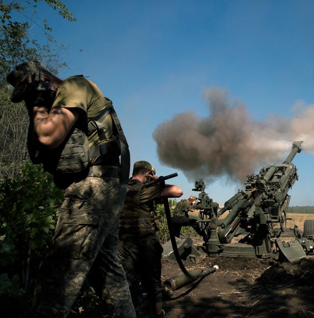 Ukrainian soldiers fire a U.S.-supplied M777 howitzer at Russian positions in the Donetsk region of Ukraine on June 21, 2022. Ukrainian soldiers are firing thousands of shells daily, forcing the U.S. to replace gun barrels across the border in Poland. TYLER HICKS / NYT