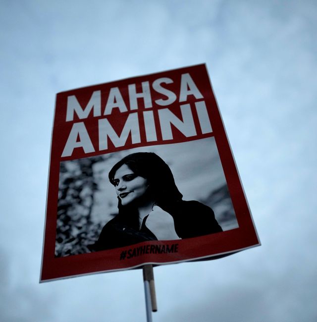 A woman holds a placard with a picture of Iranian Mahsa Amini as she attends a protest against her death, in Berlin, Germany, Wednesday, Sept. 28, 2022.  Markus Schreiber / AP