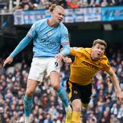 Manchester City's Erling Haaland, left, heads the ball to score his side's opening goal during the English Premier League soccer match between Manchester City and Wolverhampton at the Etihad Stadium in Manchester, England, Sunday, Jan. 22, 2023. (AP Photo/Dave Thompson)  XDB121