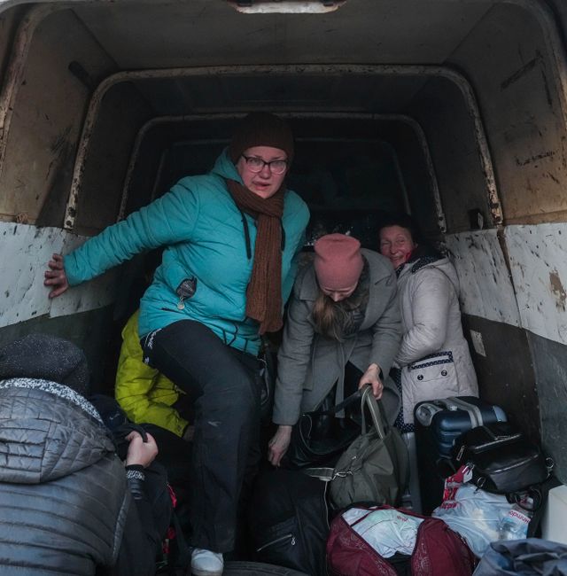 Internally displaced people from Mariupol get out from a van that they used as transport as they arrive at a refugee center in Zaporizhia, Ukraine, Friday, March 25, 2022. Evgeniy Maloletka / AP