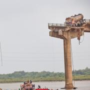 Rescuers and locals look for survivors after several vehicles fell into a river following the collapse of a portion of a bridge in Mujpur near Vadodara in the Indian state of Gujarat, Wednesday, July 9, 2025. 
