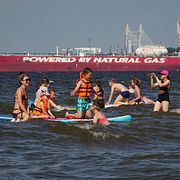 Människor badar i S:t Petersburg, med en rysk oljetanker i bakgrunden (30 juni)