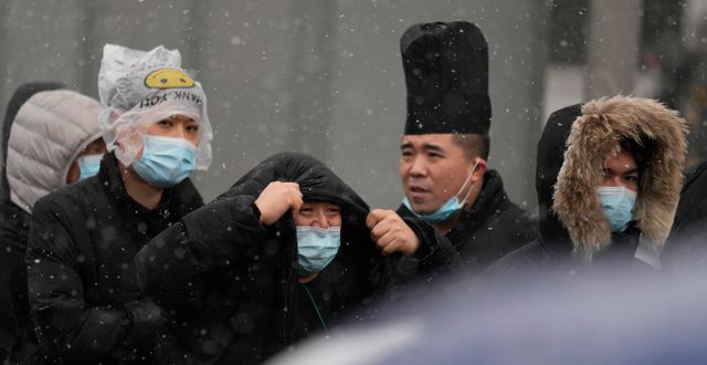 Män med munskydd i Kina. Ng Han Guan / AP
