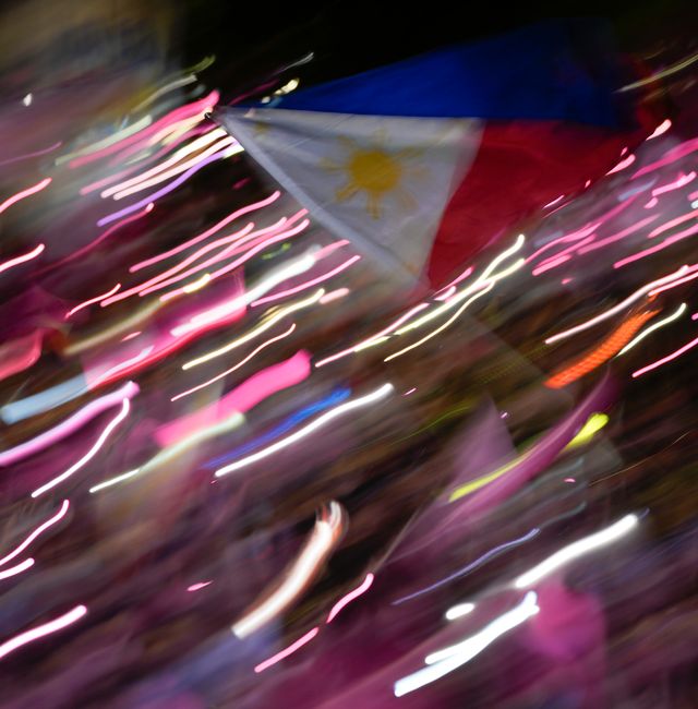  Philippine flag is waved during the presidential campaign rally of Vice-President Leni Robredo in Pasay City. Aaron Favila / AP