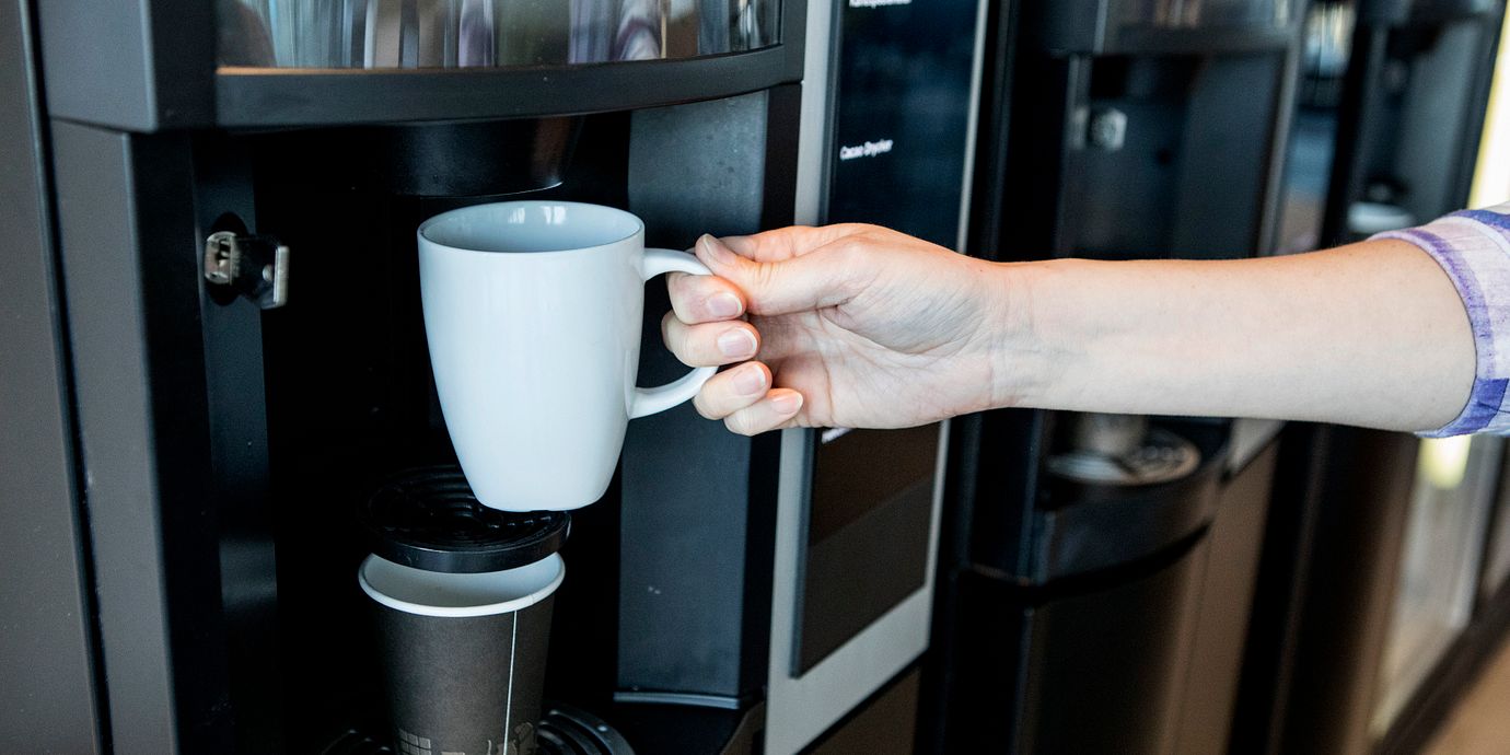 Kaffeautomat på arbetsplats. Illustrationsbild.
