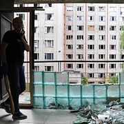 Kvinna städar upp bråte efter attacken.  Mykola Tys / AP